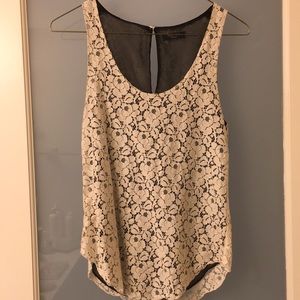 Creme floral lace blouse with black lining.